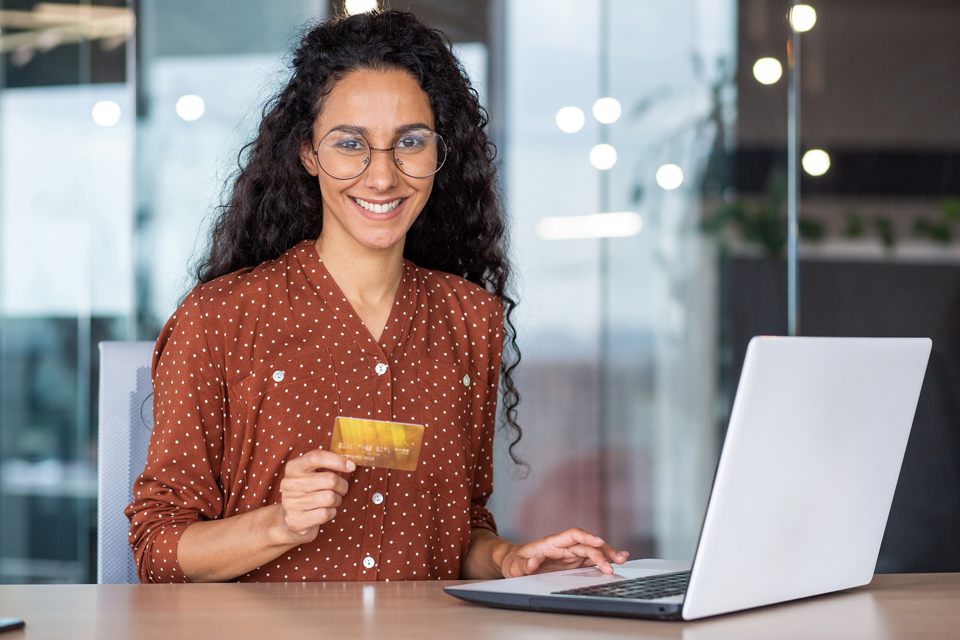 young woman with credit card and laptop